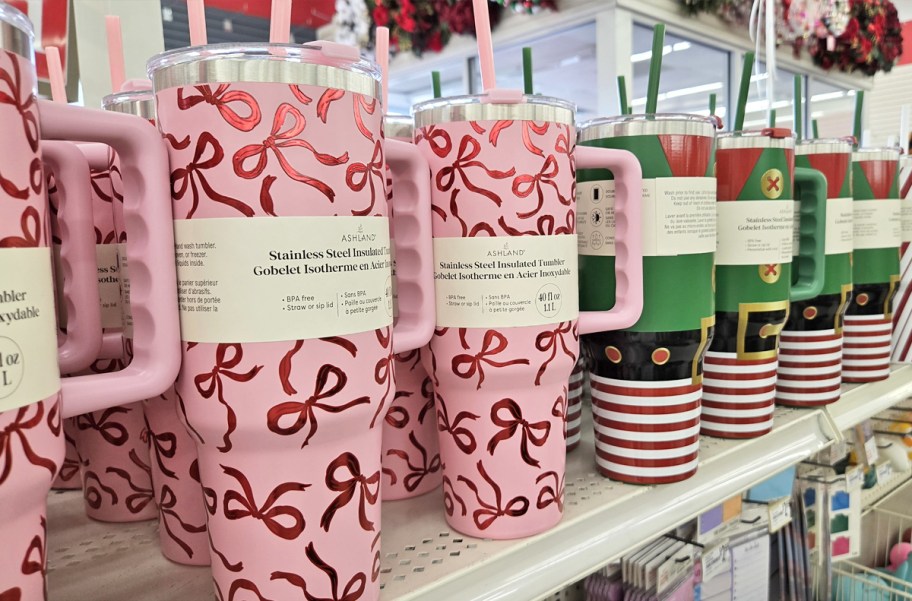 pink bows and green elf suit print tumblers on store shelf