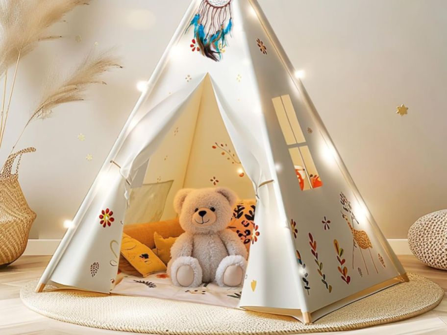 A cute indoor tent with lights around it