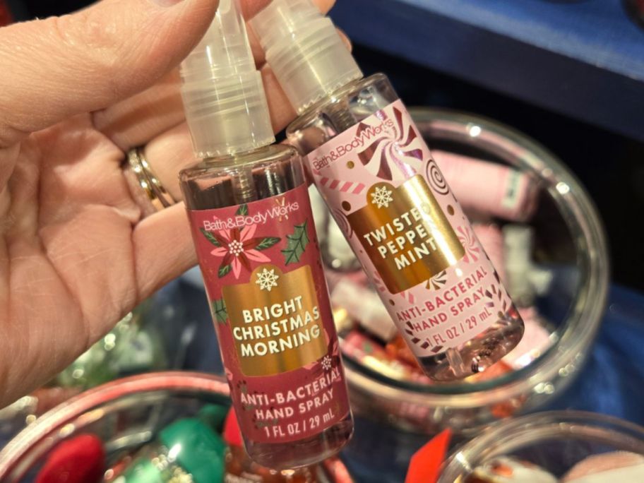 Hand holding two Bath & Body Works Hand Sanitizer Sprays