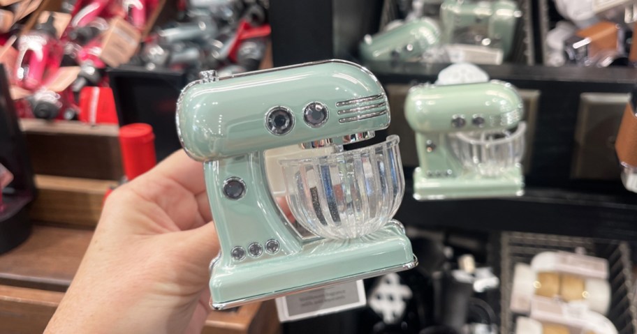 hand holding a blue Bath & Body Works Kitchen Mixer Wallflower in store