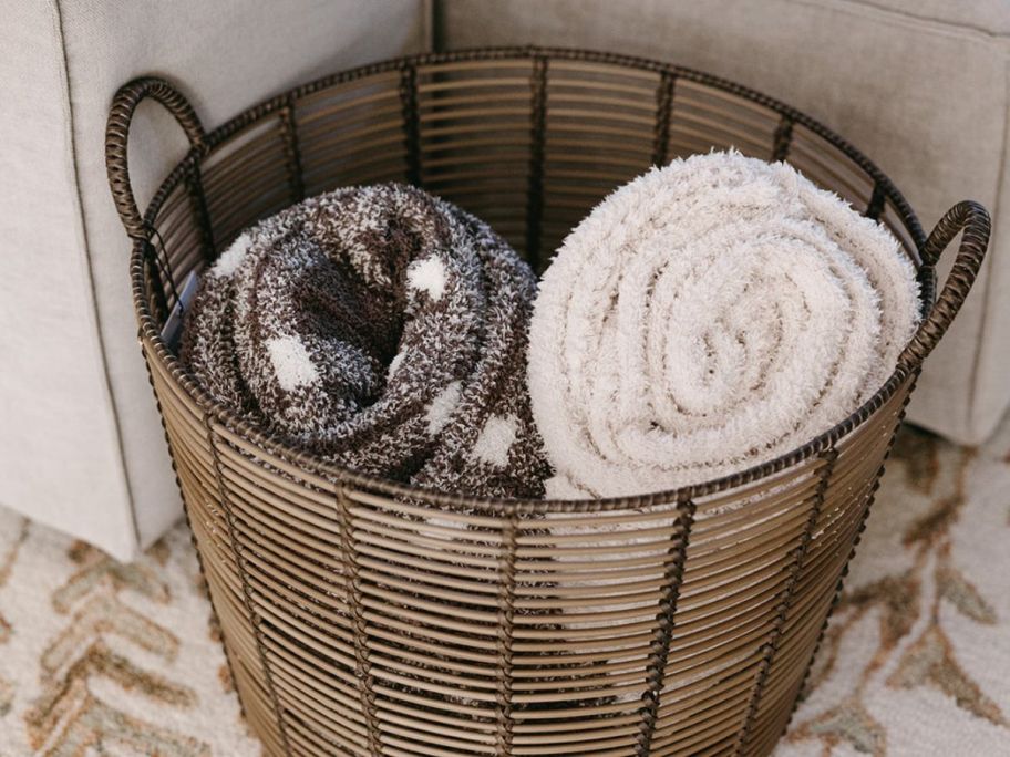 two rolled blankets in a wicket basket