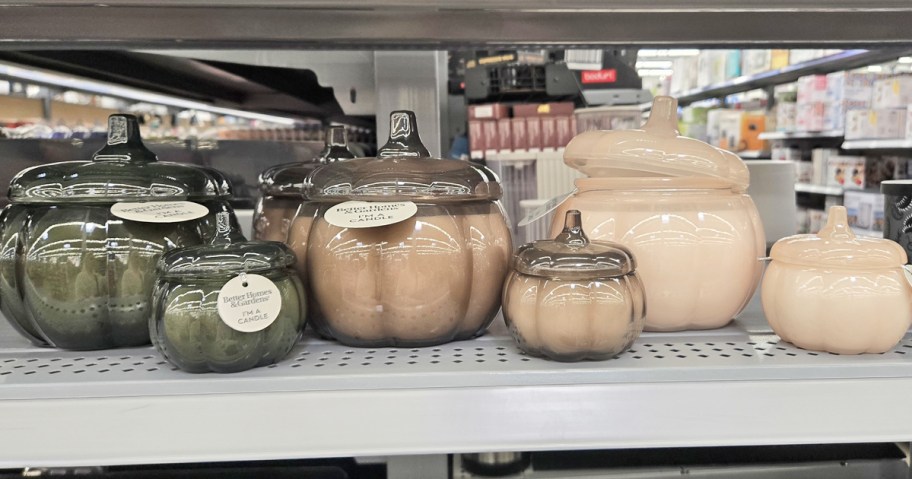 small and large glass pumpkin jar candles on store shelf