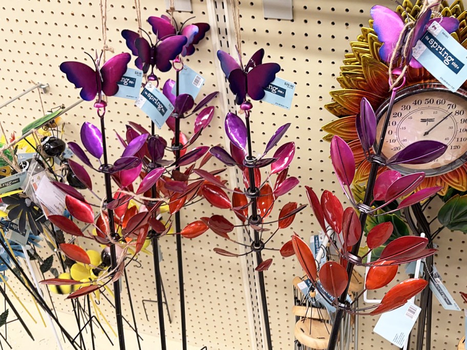 colorful butterfly garden stakes on store display wall