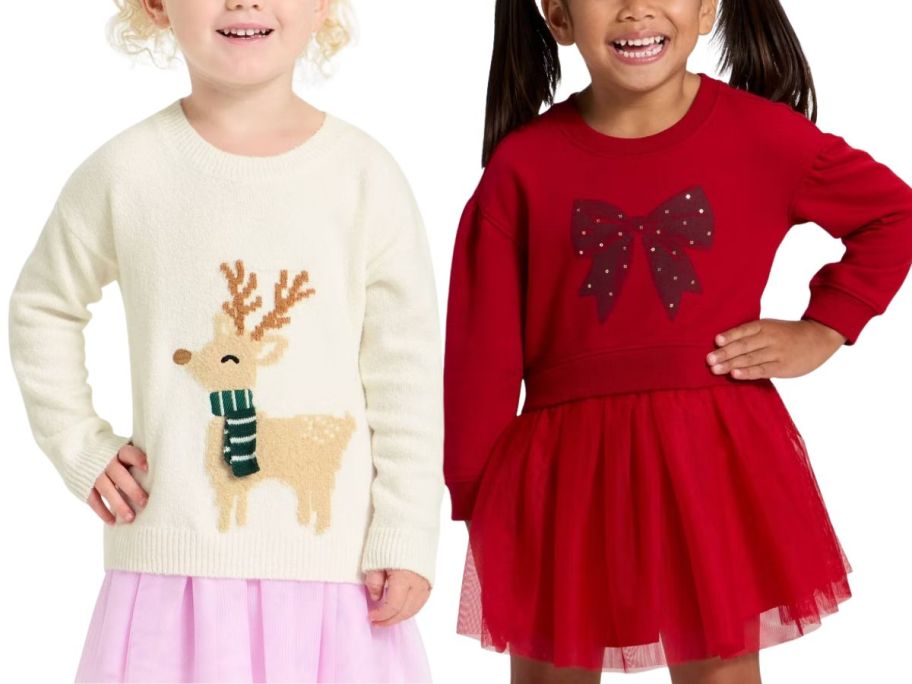 2 toddler girls wearing holiday sweaters and tulle skirts