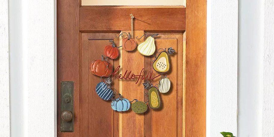 metal gourd wreath on a wood door