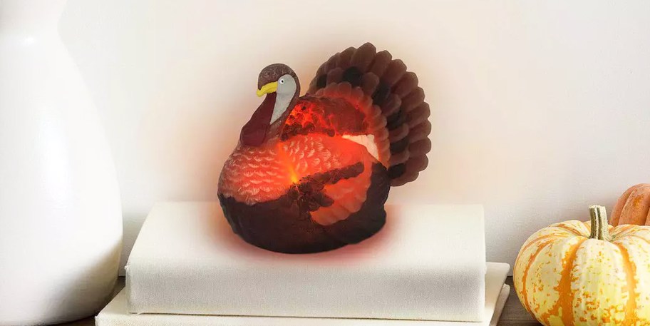led turkey candle on top of a stack of books