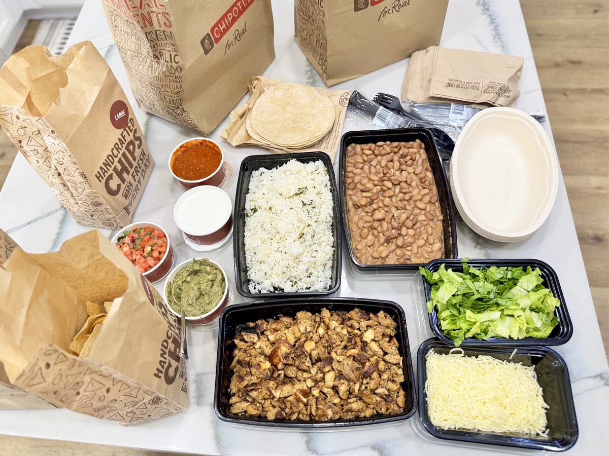individual trays of chipotle menu items on kitchen counter