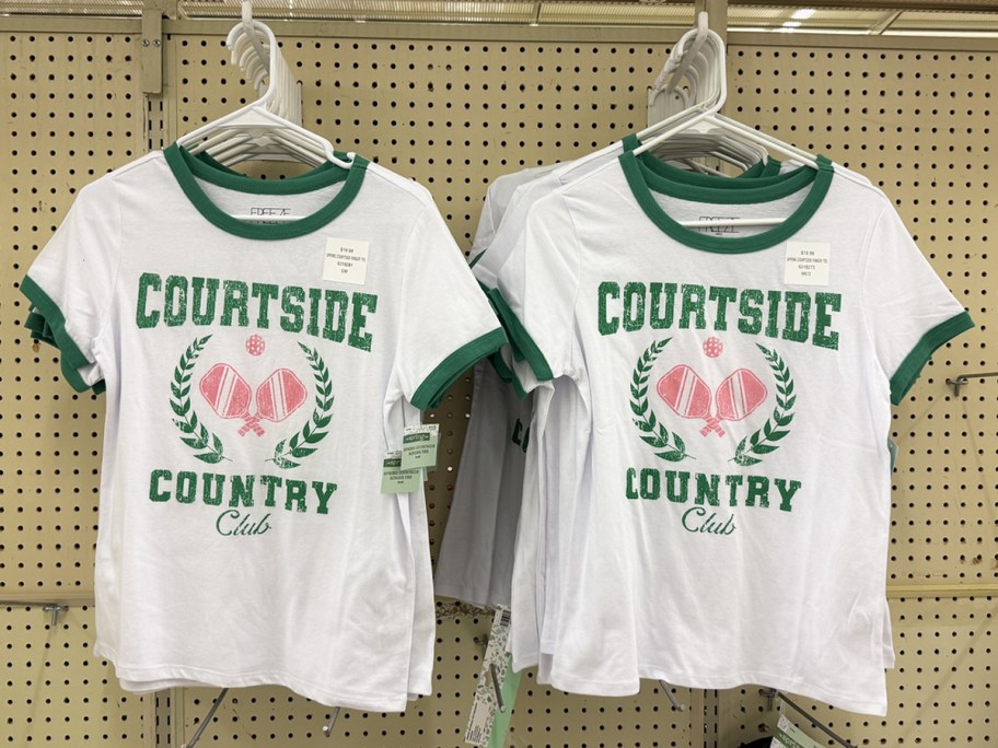 green, white, and pink tees with pickleball paddles that say courtside country club