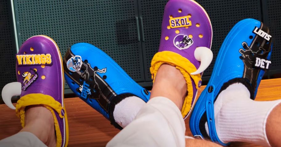 Two people wearing Crocs NFL Collection clogs