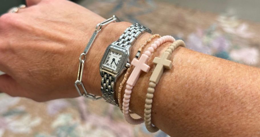 Woman's arm wearing bracelets and a watch
