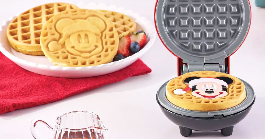 christmas mickey mouse waffle maker with plate of waffles in background