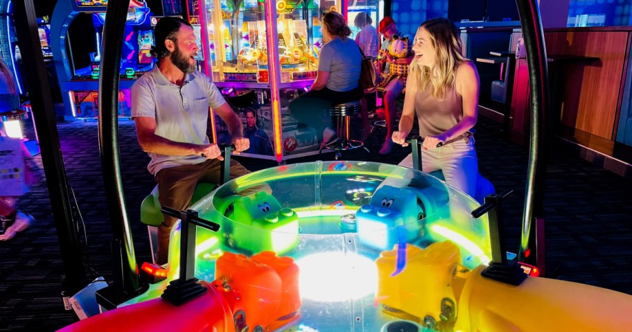 man and woman playing arcade games at Dave Busters