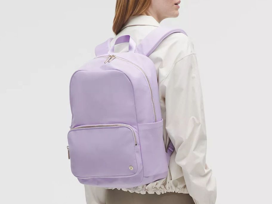 A woman wearing a purple backpack