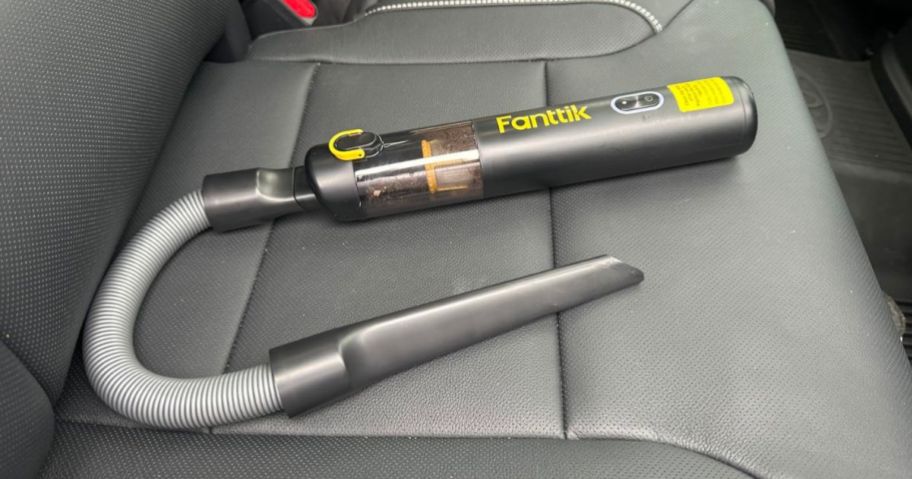 Fanttik Slim Portable V8 APEX Mini Car Vacuum on car seat