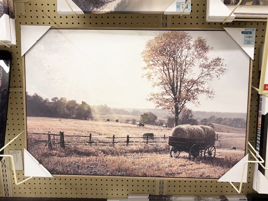 framed farm scene wall art on store display wall