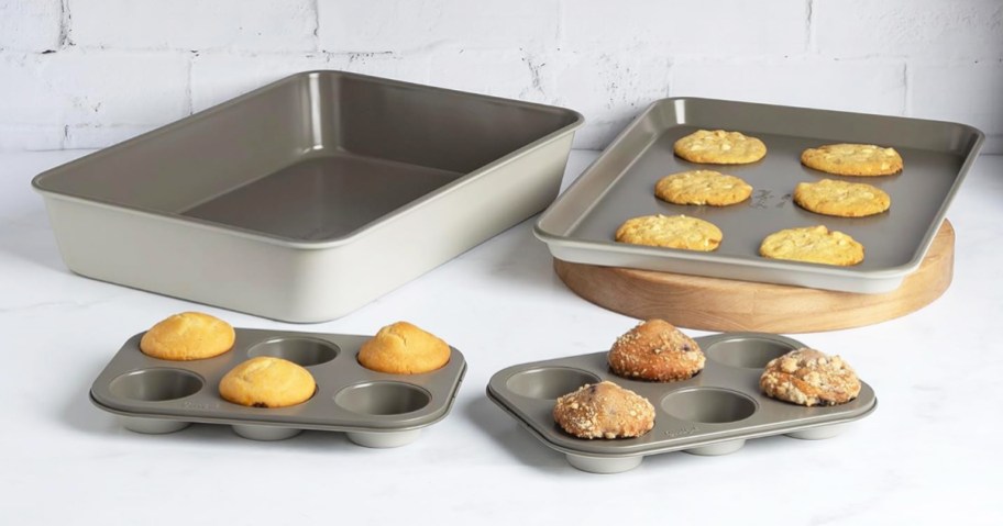 muffin tins and cookie sheets on a kitchen counter