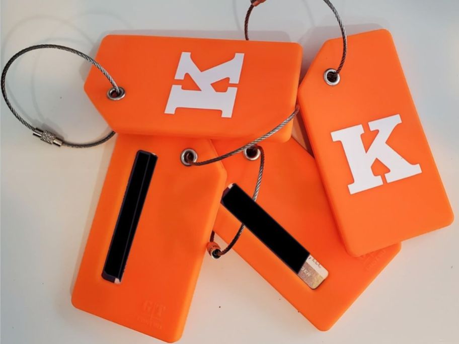 4 orange luggage tags