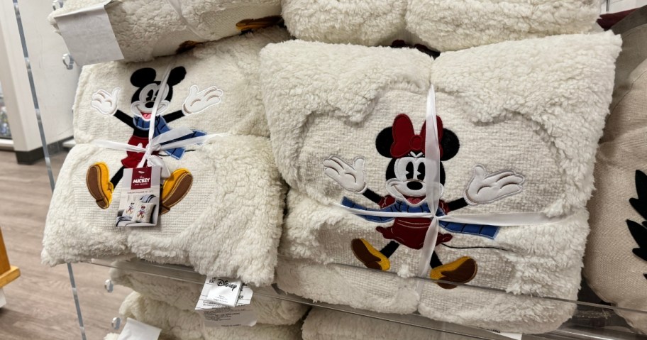 Mickey & Minnie holiday throw pillows on a store display
