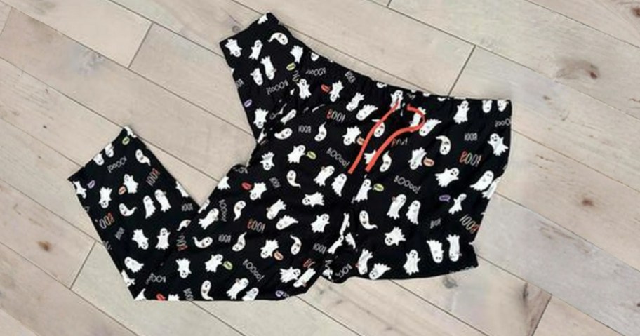 a pair of black Halloween pajama pants with ghosts on them