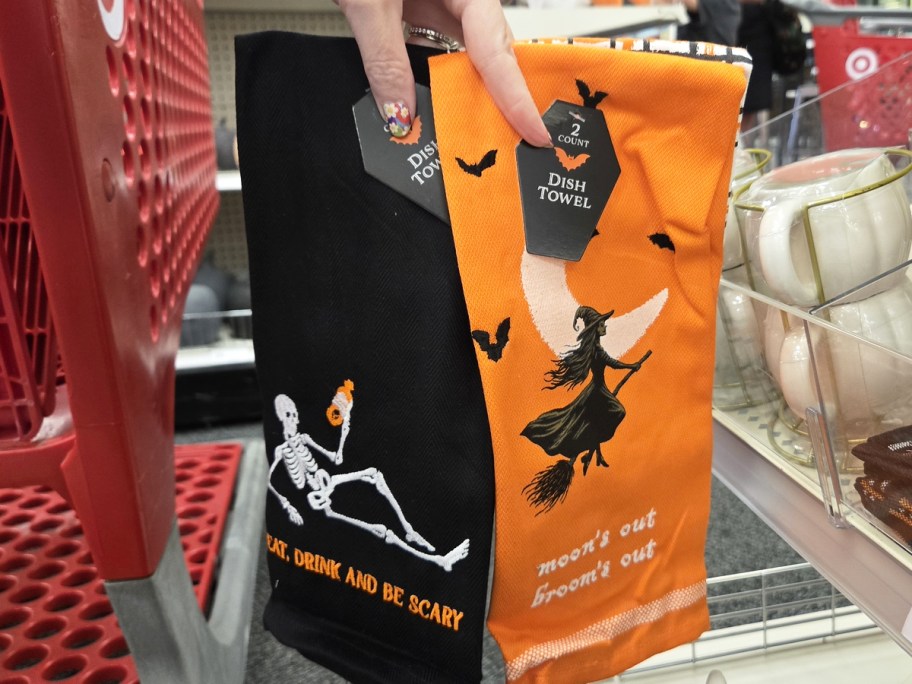 hand holding up black and orange dish towel sets