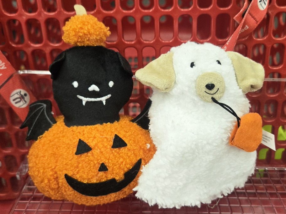 pumpkin bat and ghost dog plushies in a red shopping cart