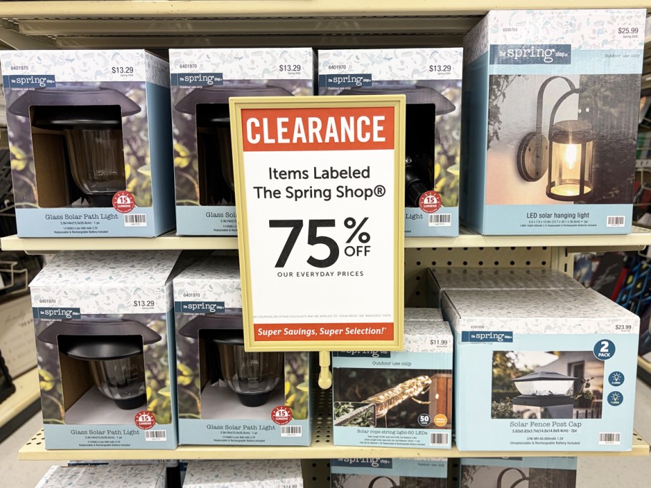 boxes of solar lights with 75% off clearance sign