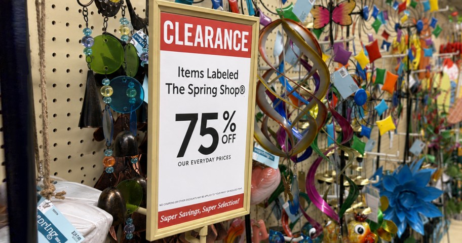 75% off clearance sign in front of metal garden decor
