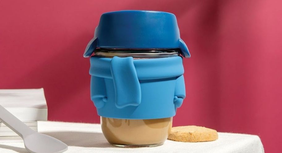 Joe mug displayed on top of the table with coffeeinside