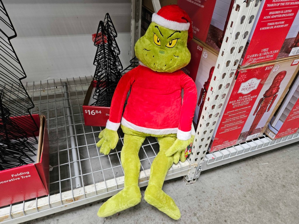 Jumbo grinch, plush with Santa hat and shirt on Walmart store shelf
