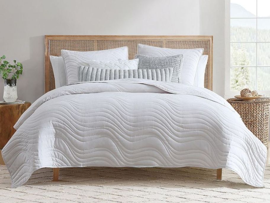 A bed with a Koolaburra by UGG Koolawash Riane Quilt Set