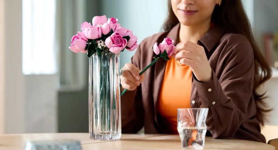 woman counting the petals on her pink bouqet
