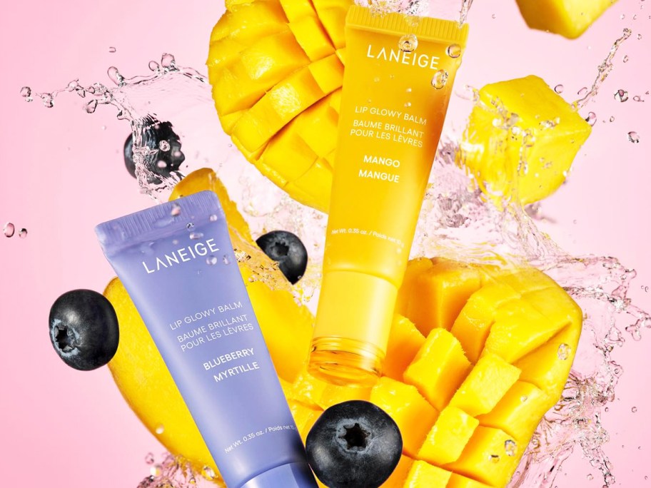 Laneige Lip Glowy Balms with mango pieces and blueberries around them