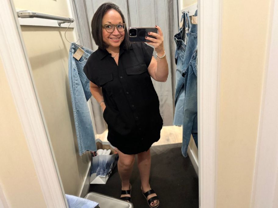 Woman wearing a Madewell dress while taking a picture of herself in a mirror inside of a dressing room