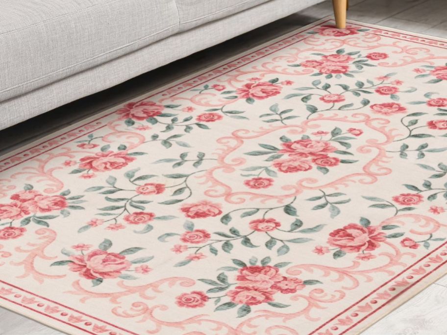 Mainstays 4'x5'6" Pink Floral Faux Fur Indoor Area Rug in front of couch