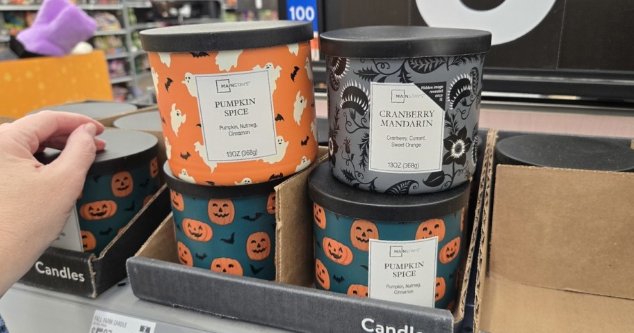 mainstays halloween and fall 3-wick candles stacked on store shelf