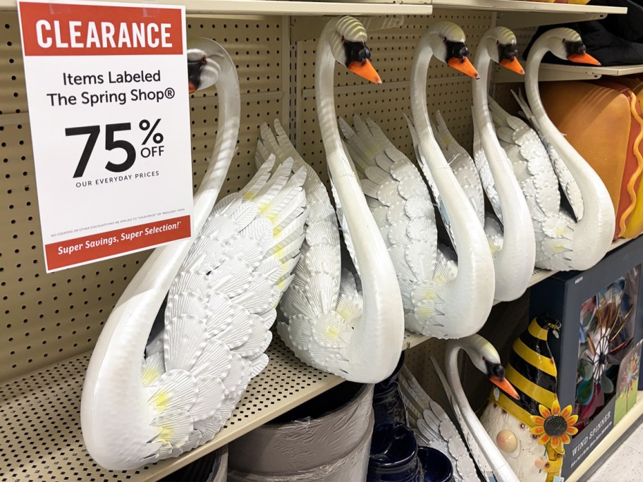 white Metal Swan Statues on store shelf with 75% off clearance sign