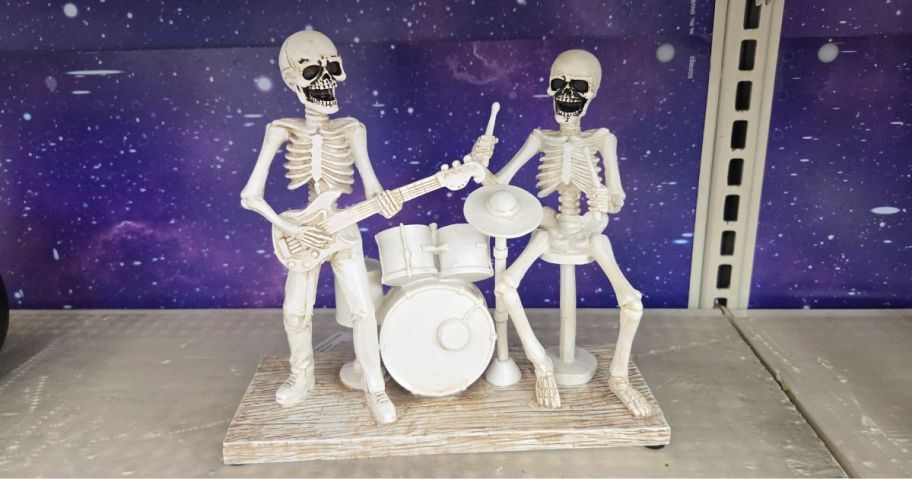 Skeleton figurines with a drum kit and guitar