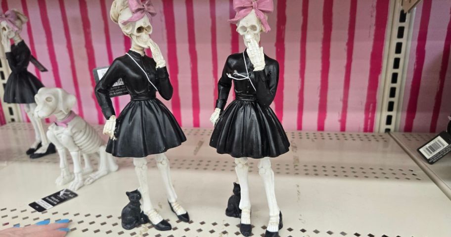 Skeleton figurines with black dresses