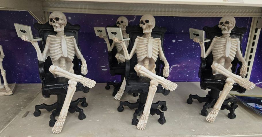 Skeleton figurines on chairs