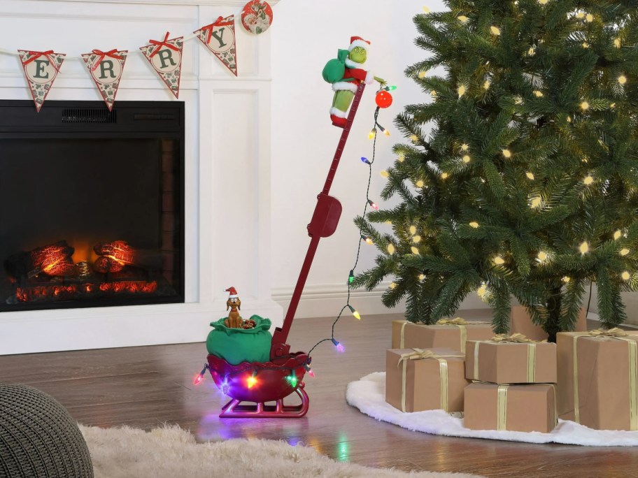 Mr Christmas Grinch sleigh by christmas tree