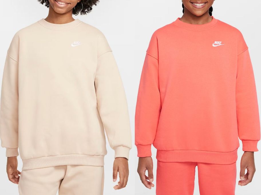 Stock images of two girls wearing Nike Sportswear Club Fleece Big Kids Oversized Sweatshirts