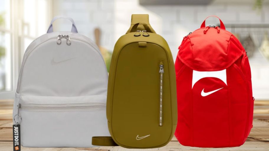 three different Nike backpacks on living room table
