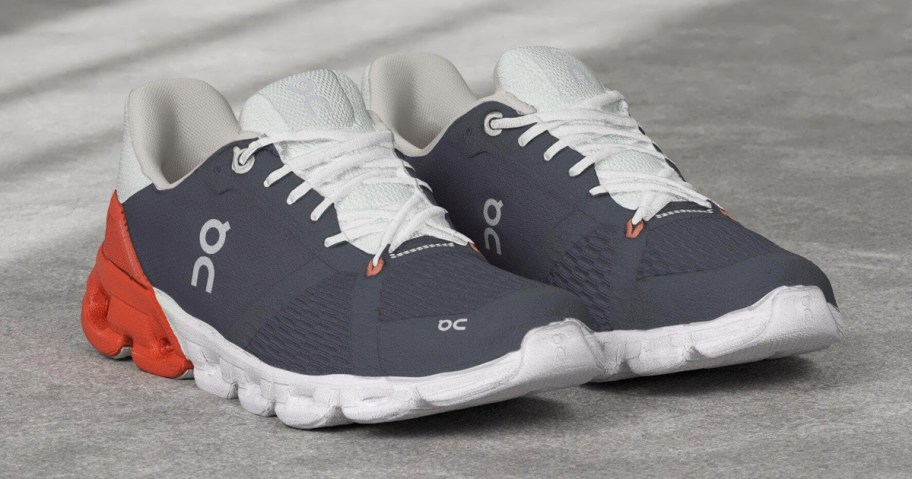 pair of navy blue, grey, and orange running shoes