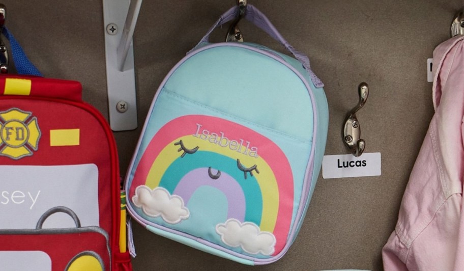 a pottery barn kids backpack with a rainbow graphic on it.