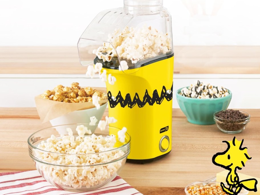 yellow charlie brown themed popcorn popper on counter