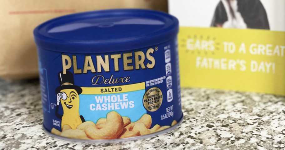 blue container of Planters Cashews on counter