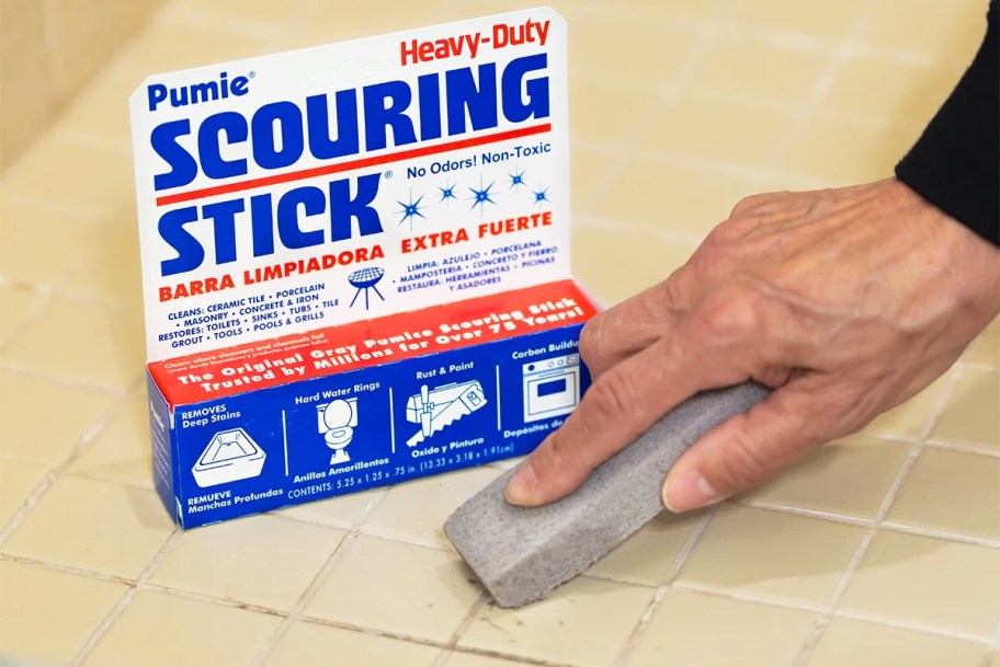 using a pumice stone to clean grout and tile