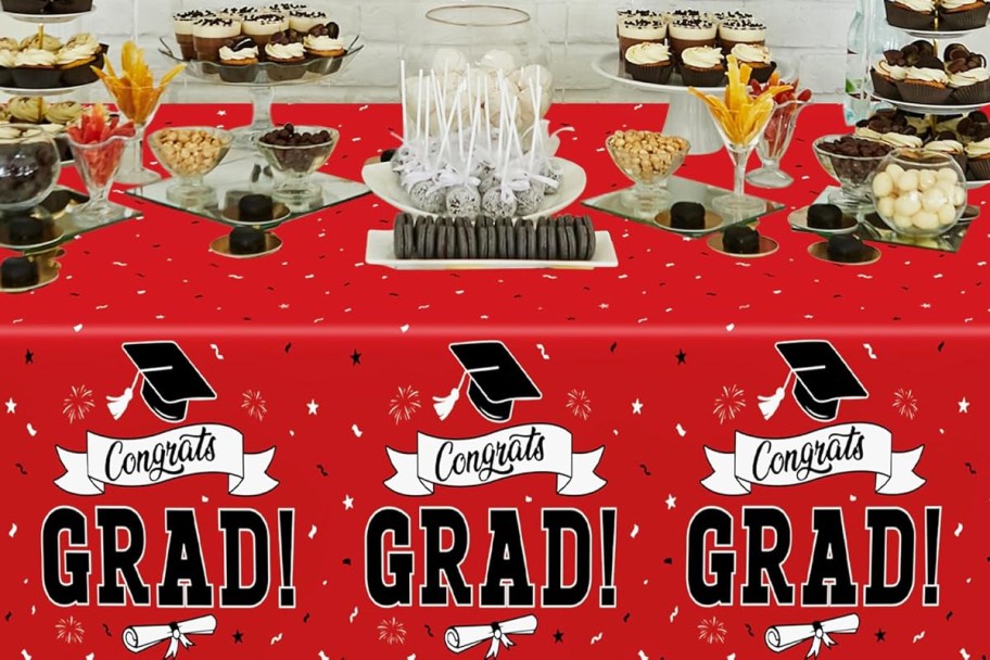 table filled with food with red graduation tablecloth 