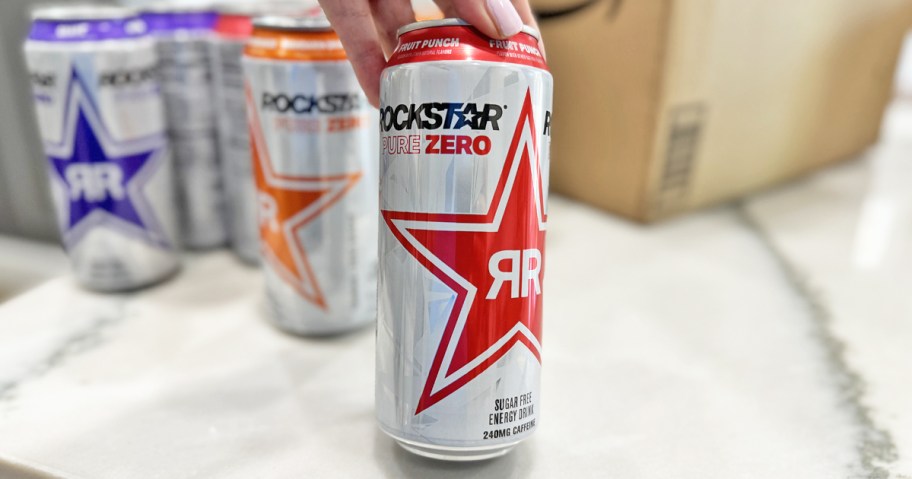 hand holding a can of Rockstar energy drink in fruit punch flavor