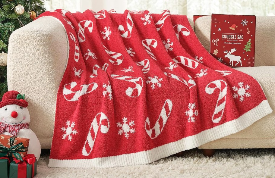 red candy cane print throw blanket on a couch